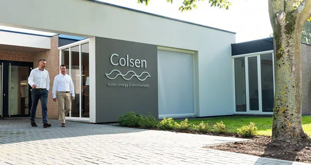 Two employees walking out of the Colsen office.